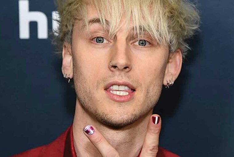 Machine Gun Kelly showcases bold evil eye nailart Machine Gun Kelly showcases bold evil eye nailart